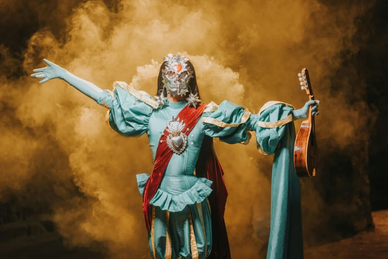 a woman in blue is performing an artistic costume