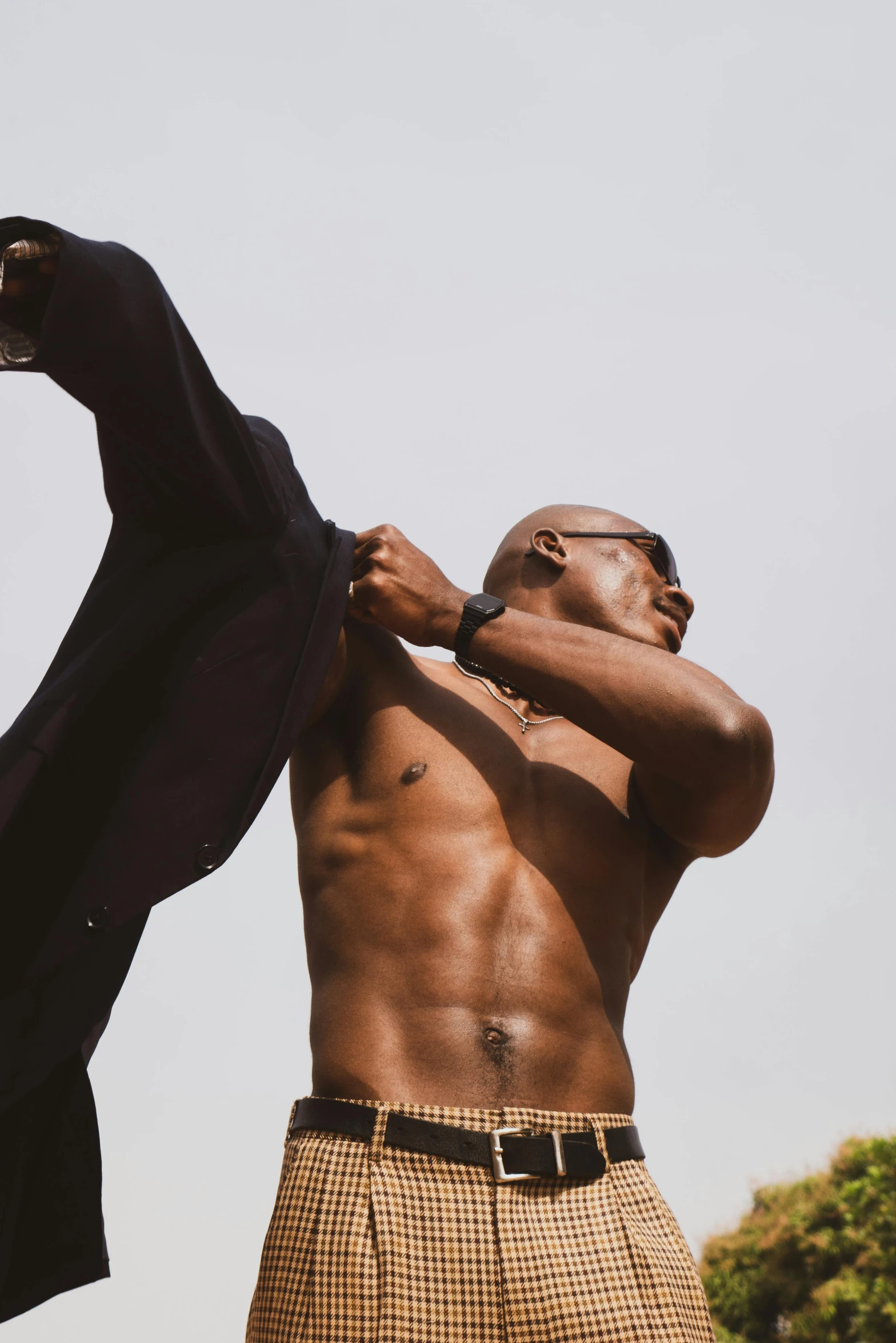 an african man holding up a black shirt