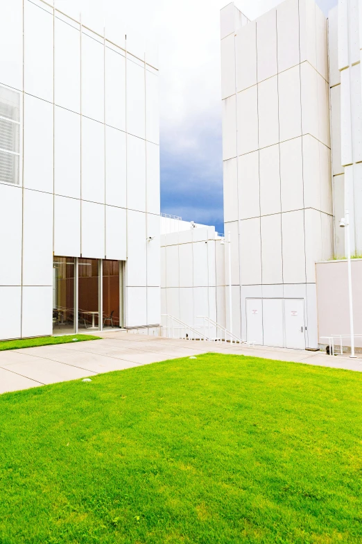 an empty lawn near the front of a white building