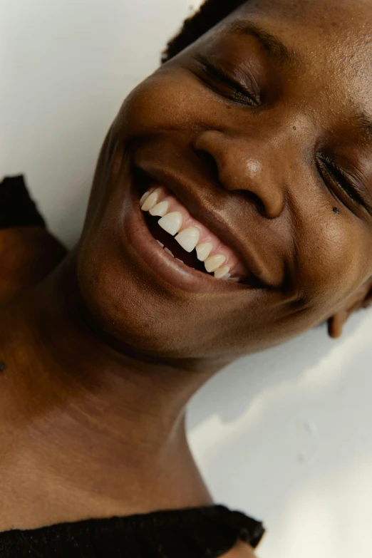 smiling black woman with ces on neck and chest