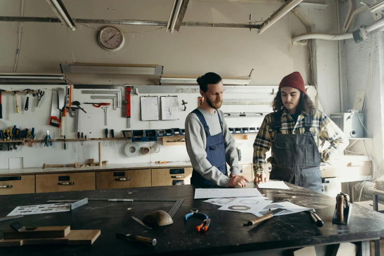 a man and woman are in a workshop