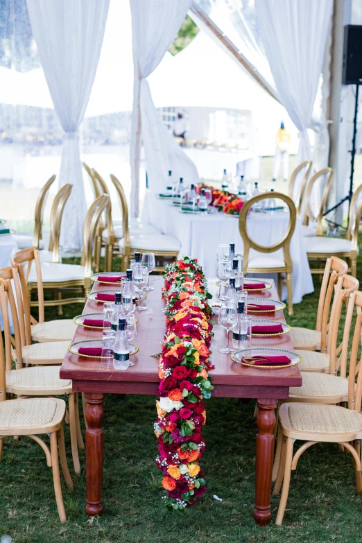 table setting with orange, green and red flowers and napkins