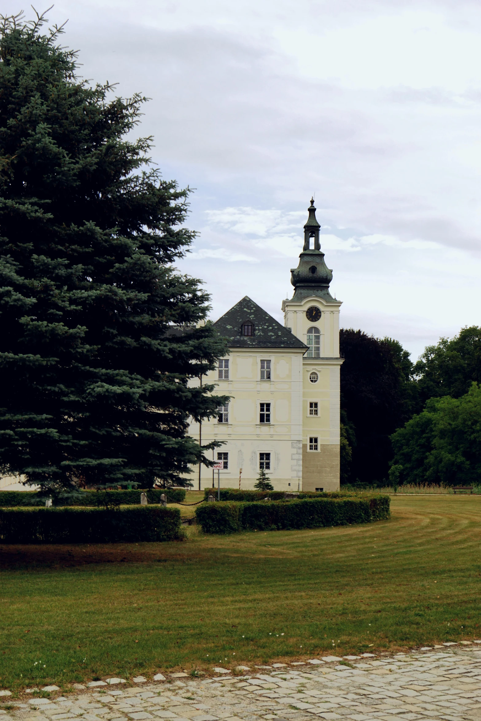 an architectural tower with spire on a park