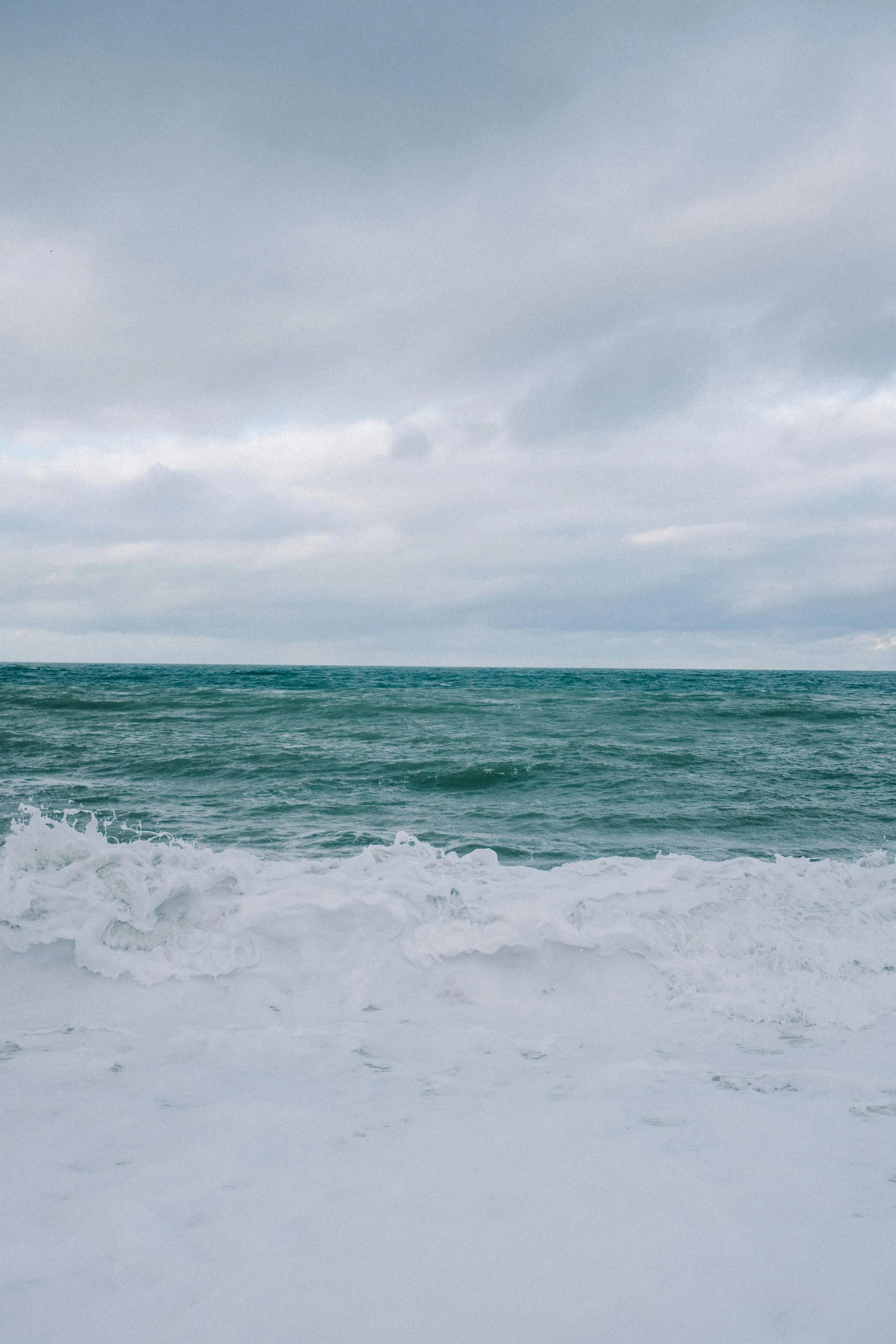 a large body of water surrounded by waves