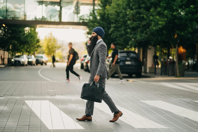 a man in a suit walking across a crosswalk