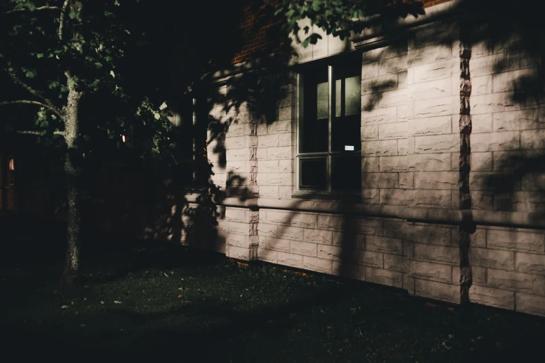 dark shadow on white brick wall at night