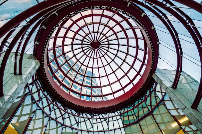 looking up at the glass dome in a building