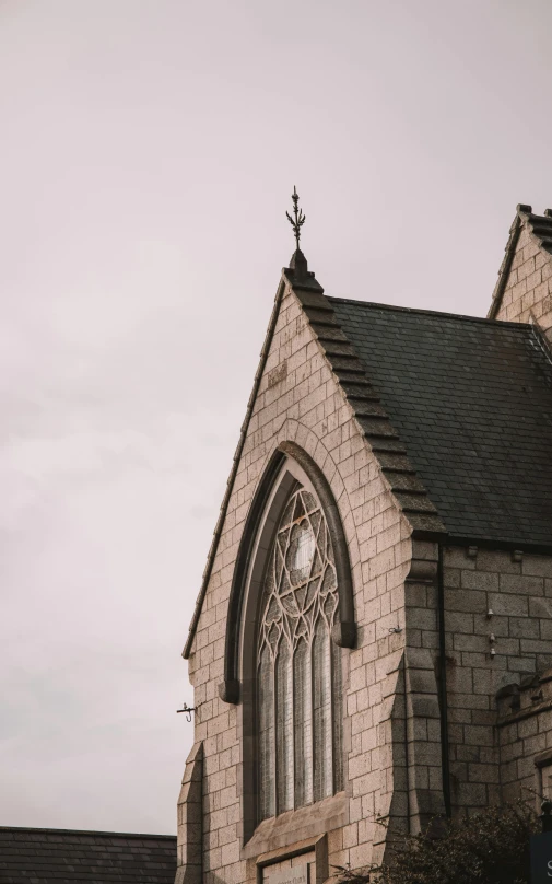 a brick church with stone walls and gothic windows