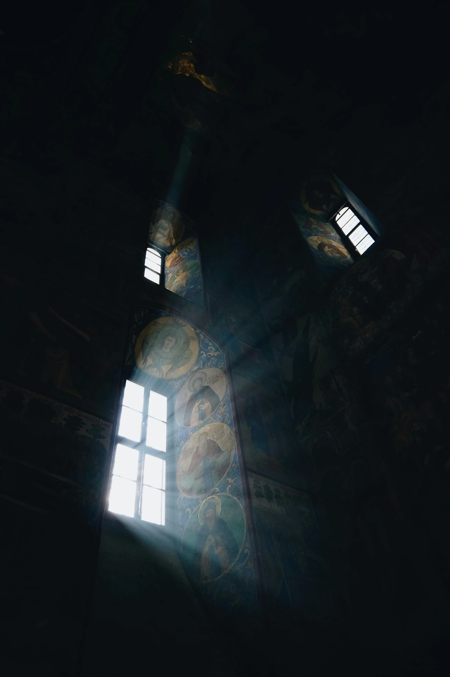 light shining in through two windows in a building