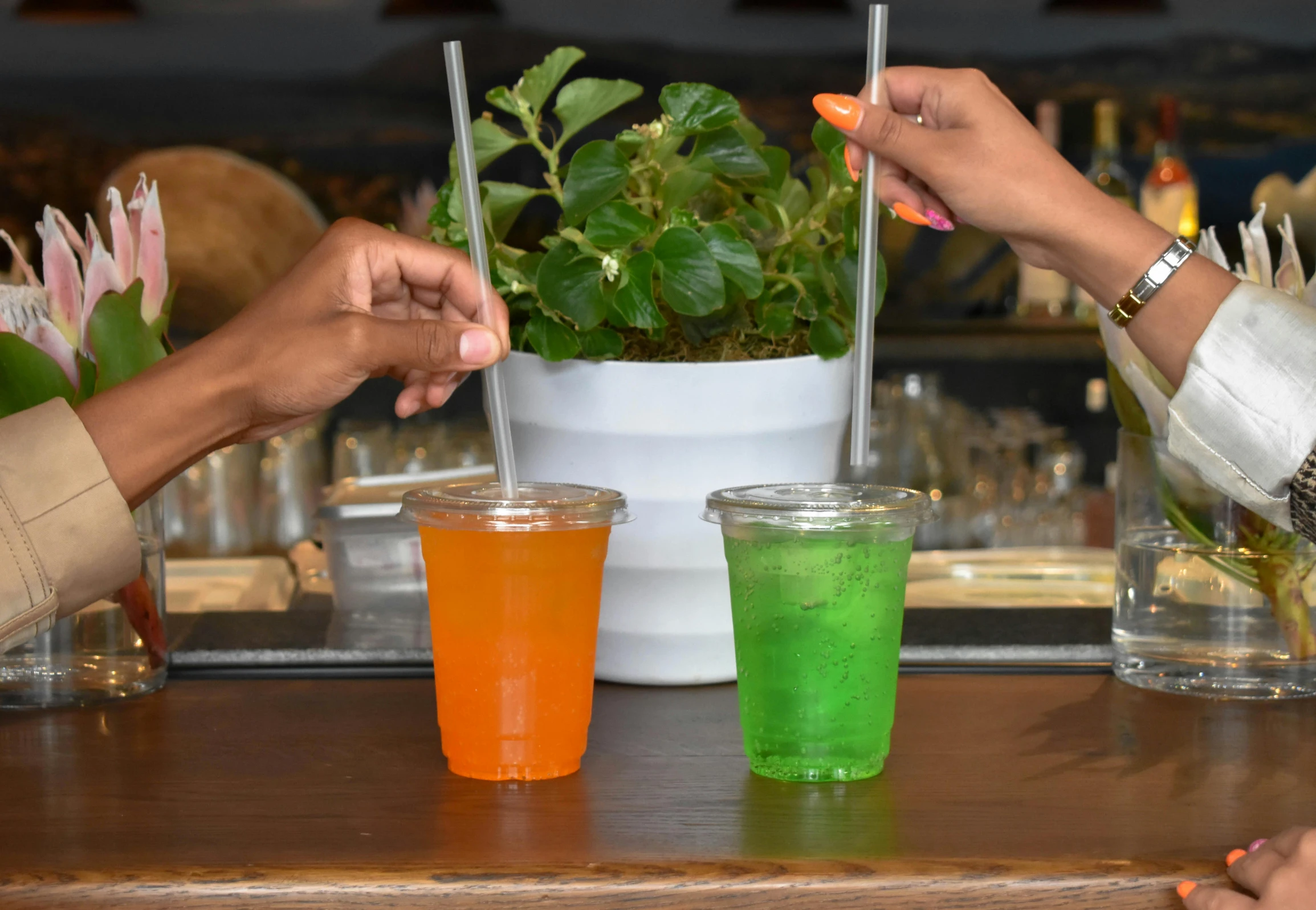 a group of people are drinking soing on a table