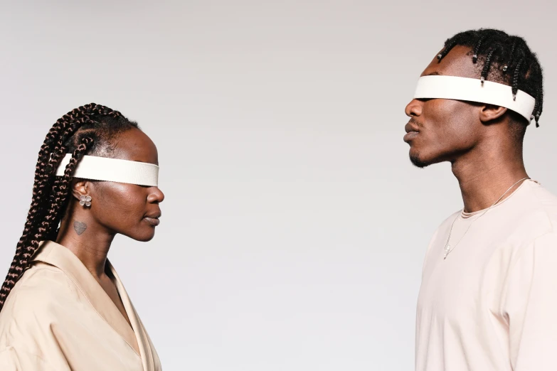 a couple of people with blindfolds standing next to each other