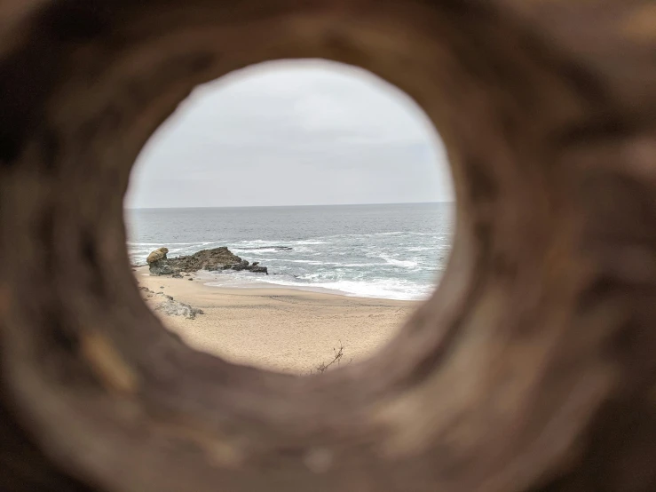 the ocean seen through an ornate porthole window