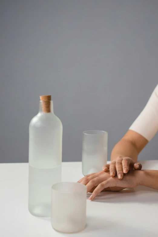 a person placing their hand on some very large bottles