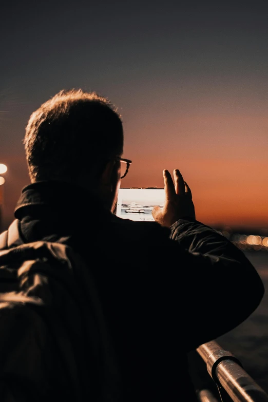 a person that is taking a picture in the sky