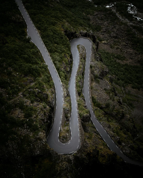 an overhead s of a winding road in the mountains