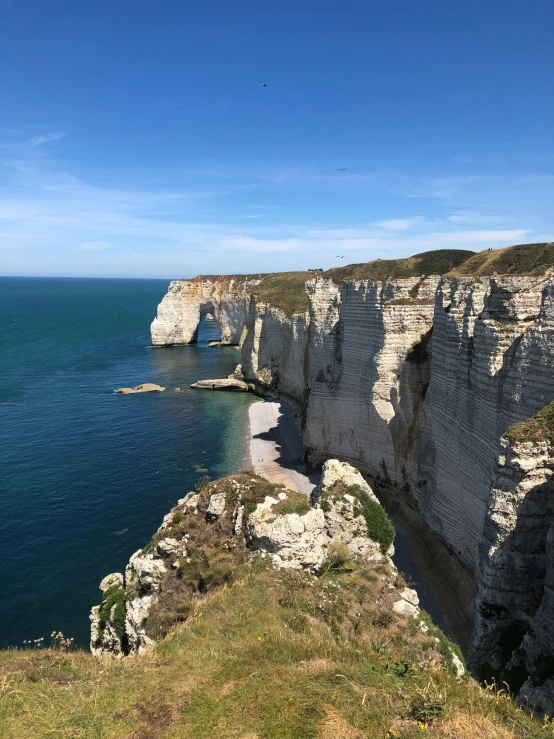 a view of the coastline at an empty cliff near water