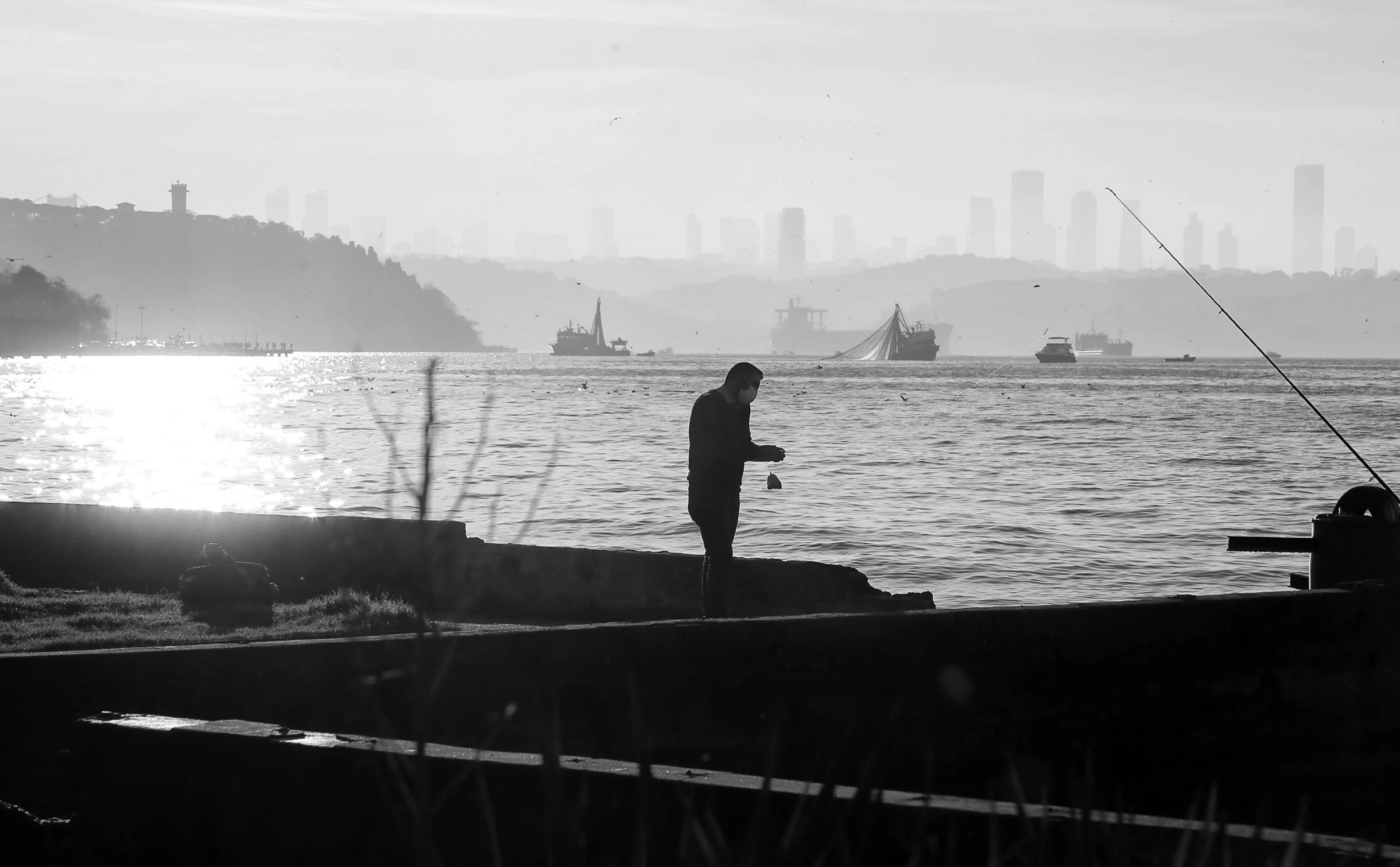 a man fishing in the ocean with his fishing rod