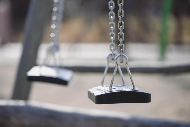 a couple of swings that are next to each other