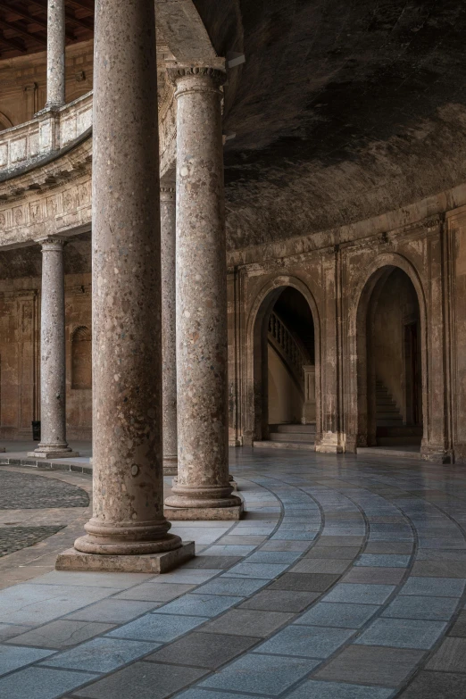 columns in a very large room with a clock