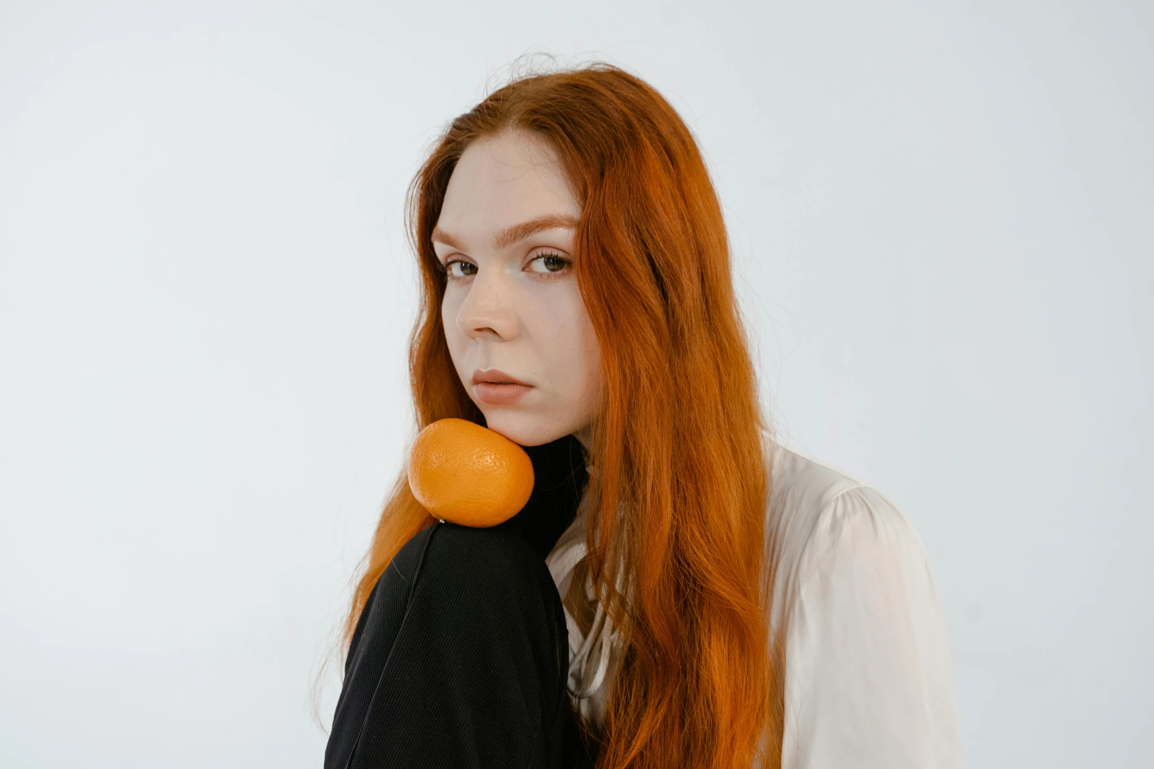 a woman with red hair and oranges in her hair