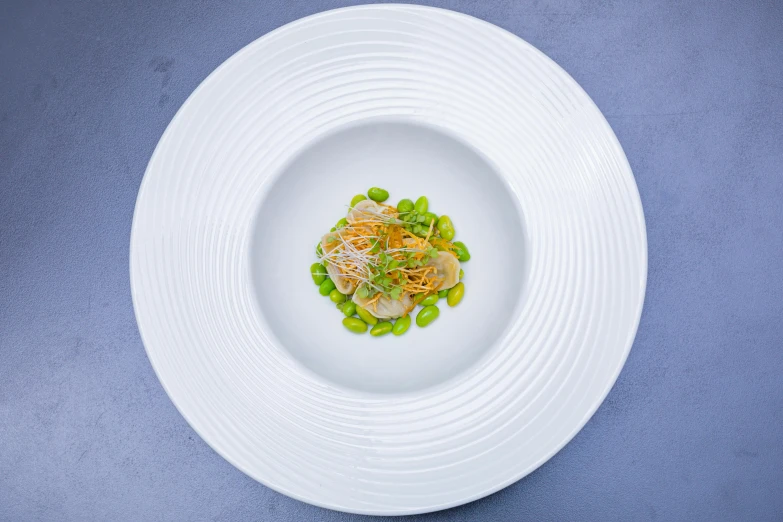 a white bowl filled with vegetables and a garnish