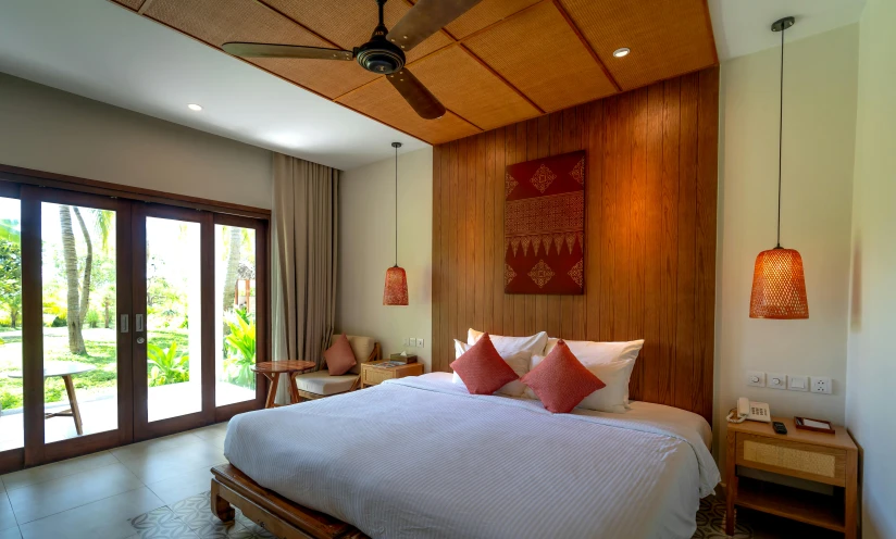 a bedroom is furnished with a bamboo ceiling fan