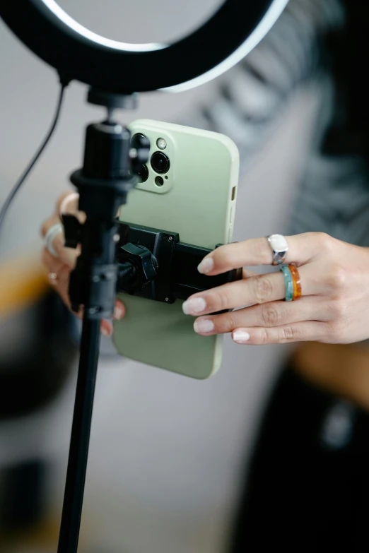 a close up of a person holding a phone in front of a camera