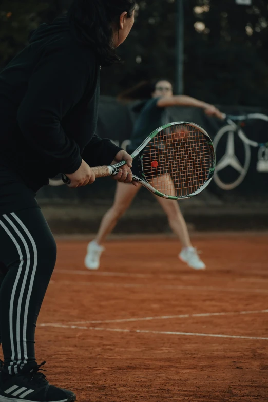 a couple of people on a court with tennis rackets