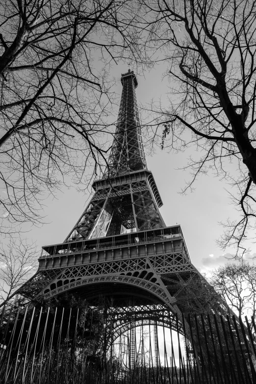 the eiffel tower as seen from behind a fence