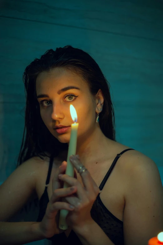 a girl holding a candle with one hand