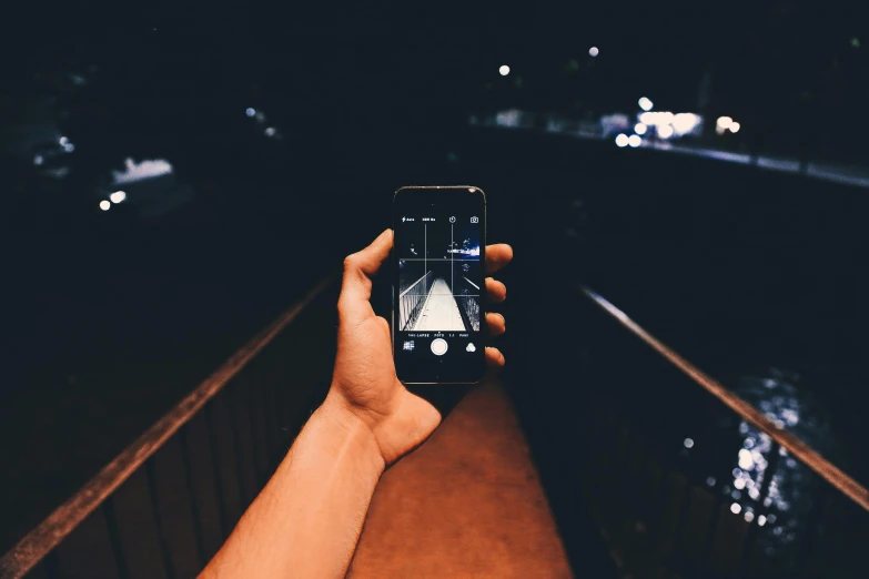a person holding up a cell phone while it's showing the image