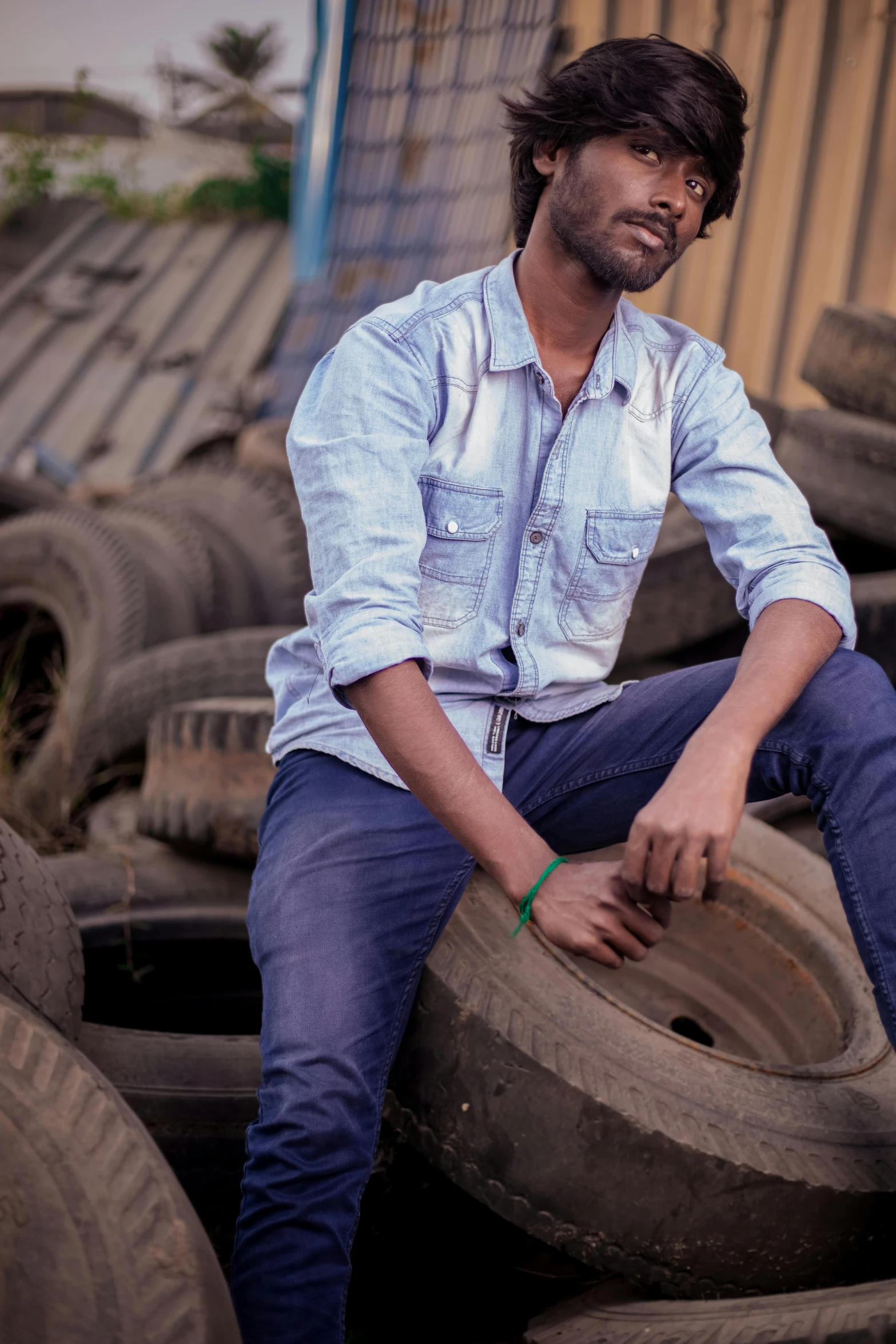 a man is sitting on top of tires