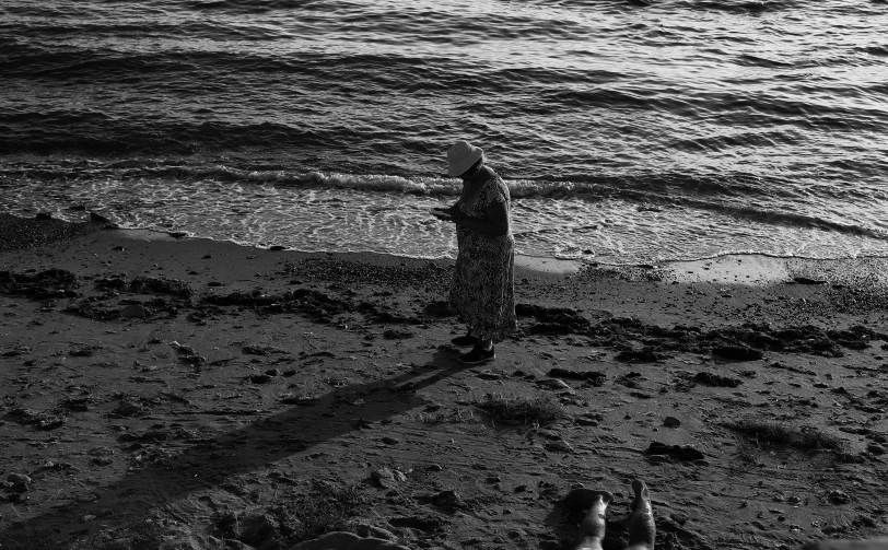 person on the beach standing with their arms in the air