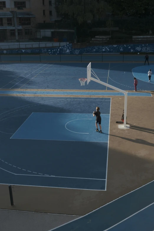 people are playing with a basketball court near a basketball court