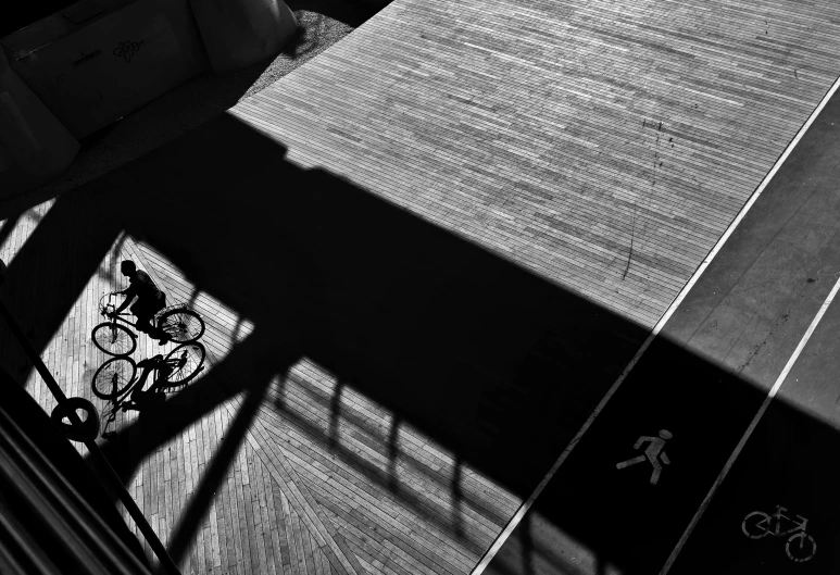 a bicycle parked on a walkway next to a parking meter