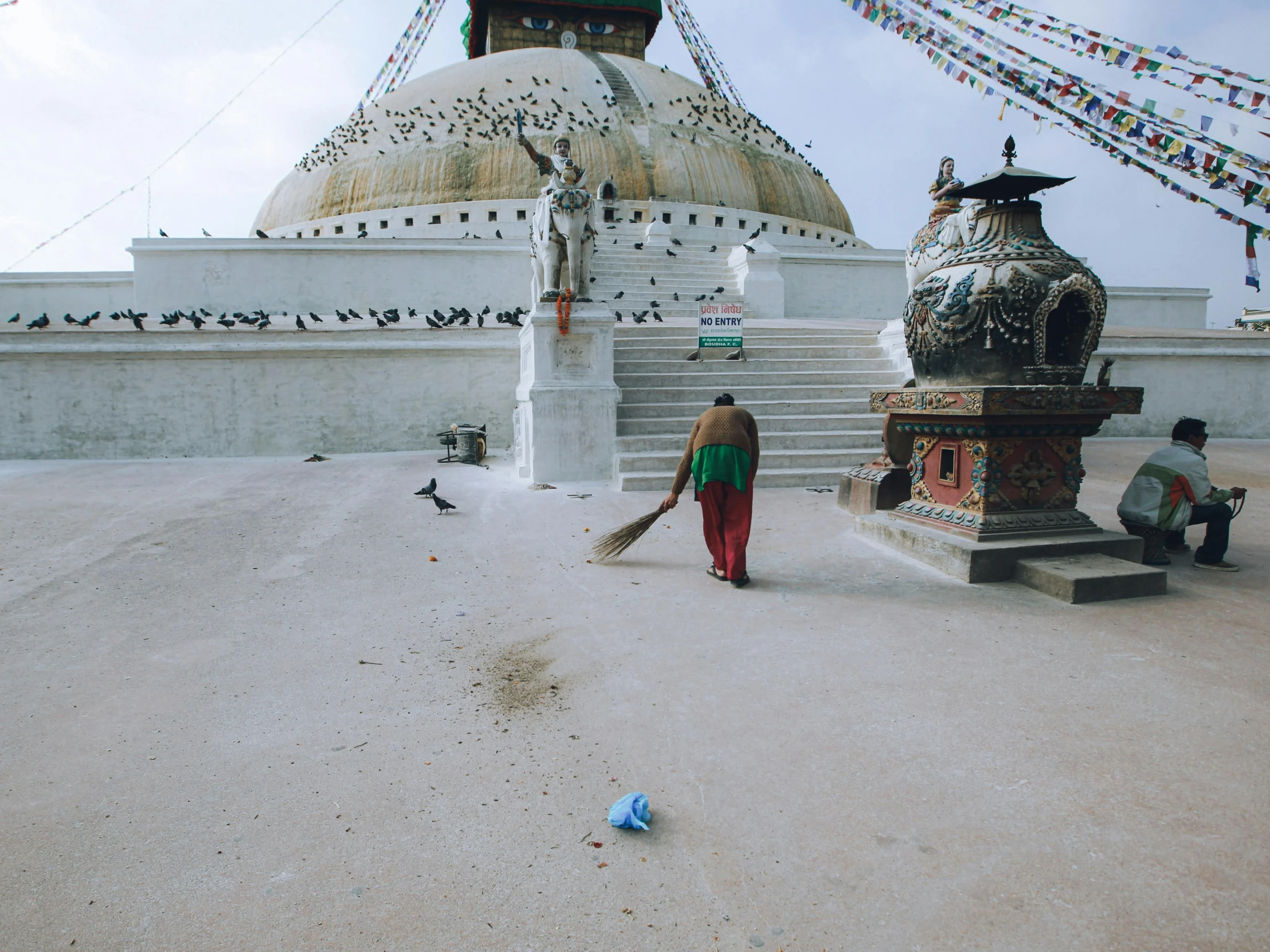 the two people are walking towards a shrine