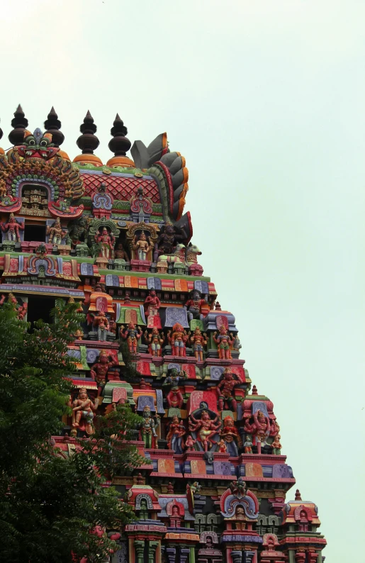 ornate temple in middle of green area with trees