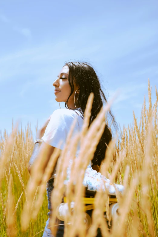 the woman stands in a field next to tall grass