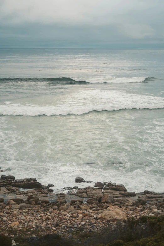 a man riding a surfboard into the ocean