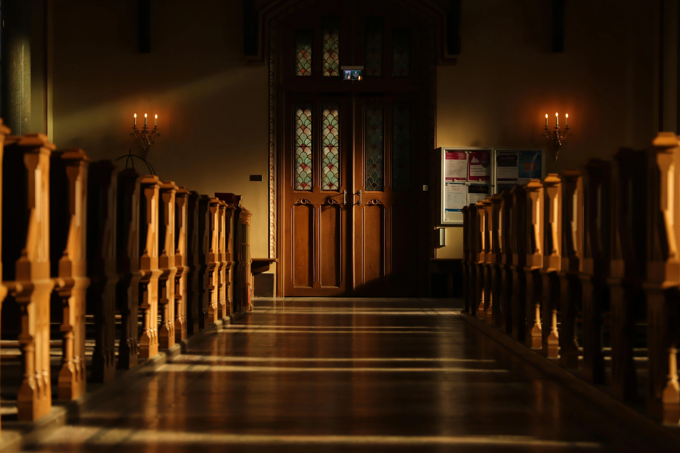 the long hallway leads to another room that has a glass paneled entrance