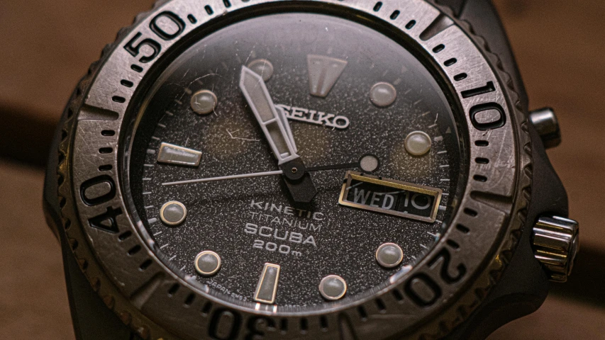 a watch with a black dial and silver celet