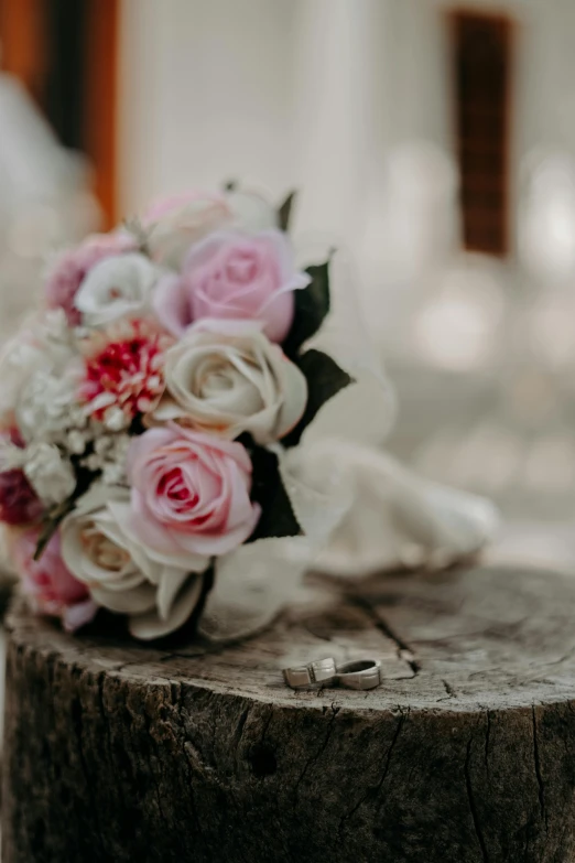 a bouquet of flowers sitting on top of a tree stump