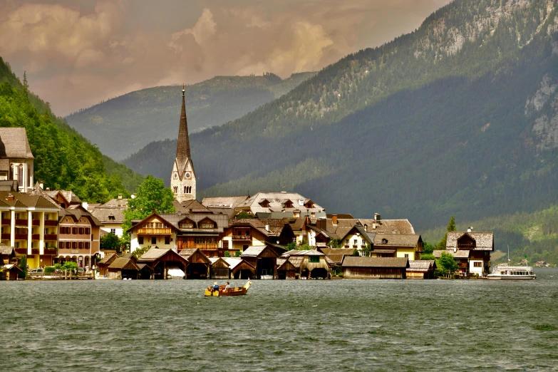 two boats floating in a body of water next to a village