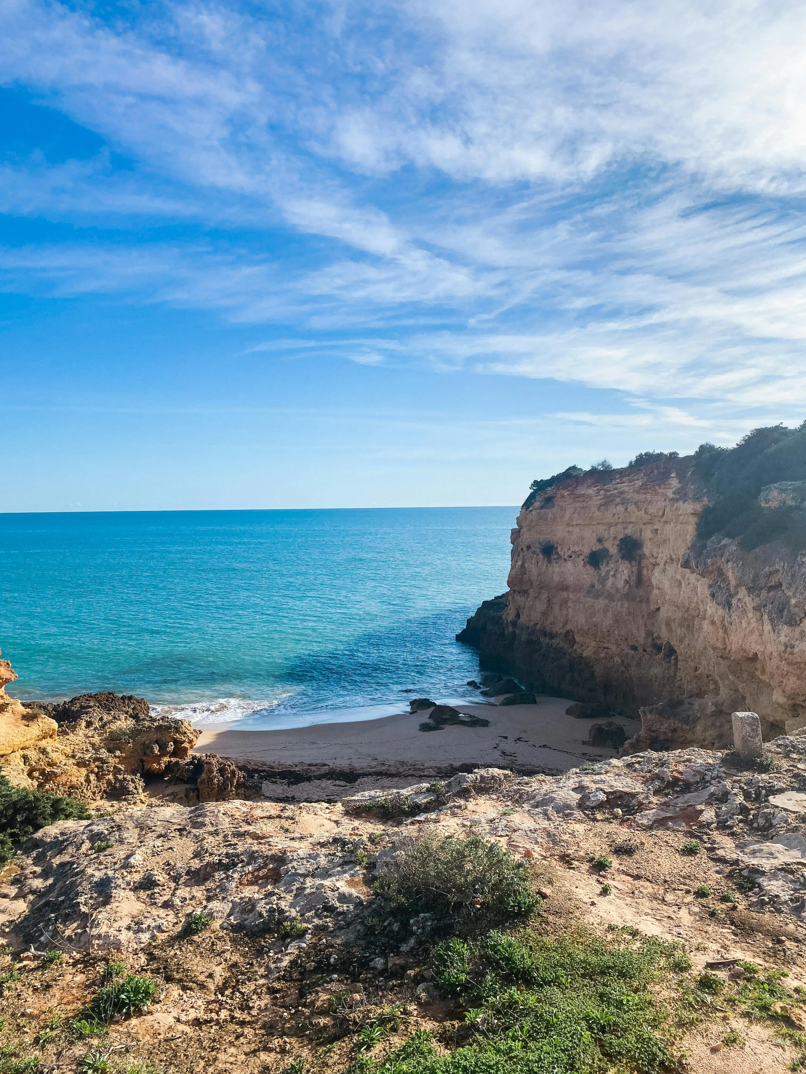 there is a beach next to a rock formation