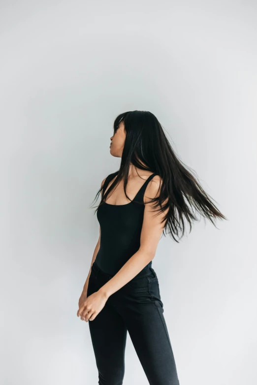 a woman with long hair is standing by herself