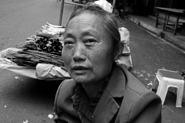 a man sits in front of an outdoor food cart