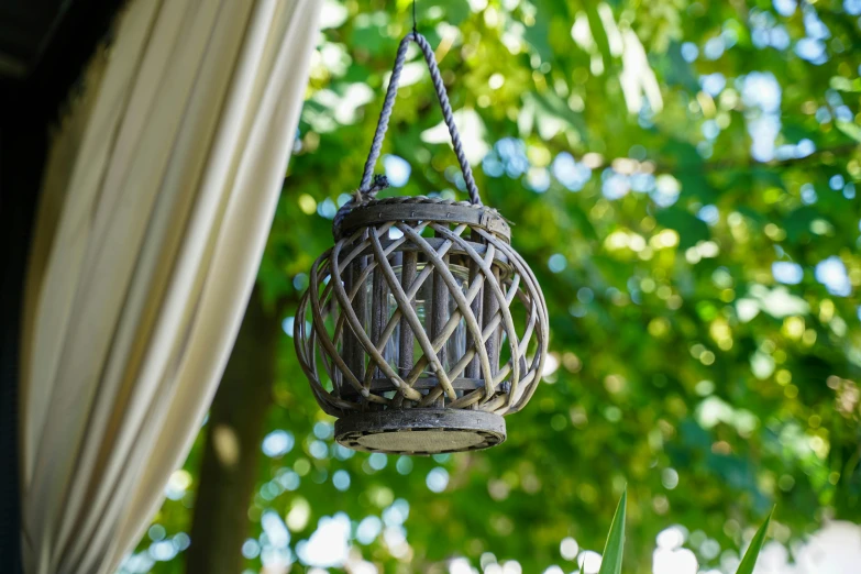 a light hanging over a patio with trees in the background