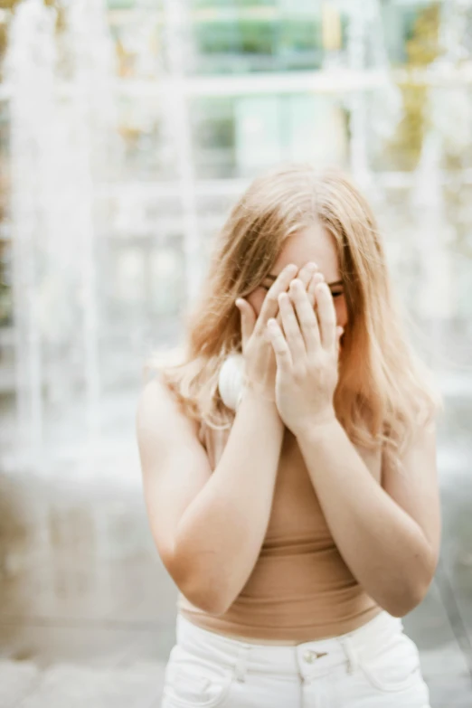 a woman covering her mouth and covering her eyes