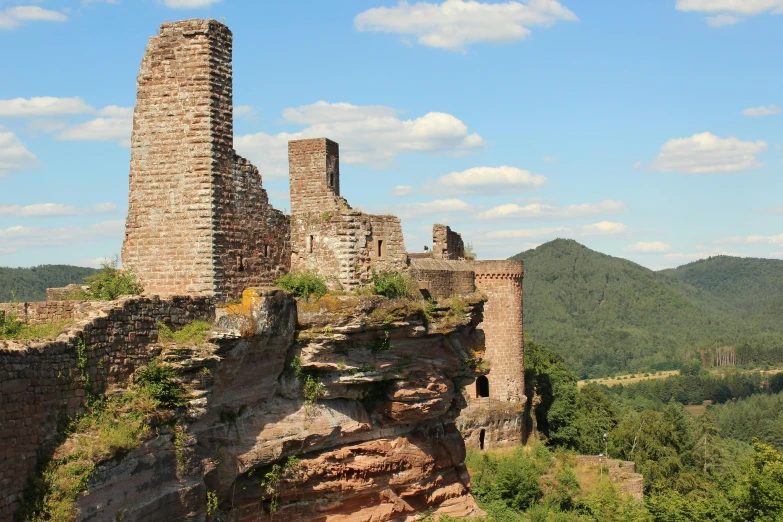 an old ruins is set in the woods near mountains