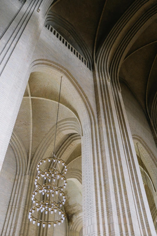 the high vaulted walls of a cathedral with a chandelier